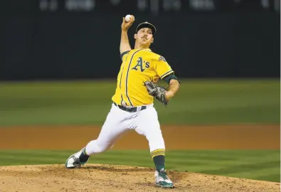  ?? Photos by Lachlan Cunningham / Getty Images ?? Daniel Mengden carried a shutout into the ninth inning on a cold night at the Coliseum, holding the White Sox to six hits and a walk.