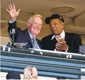  ?? JOSE CARLOS FAJARDO/STAFF ?? Vin Scully waves to the crowd while standing with Willie Mays in the broadcast booth Sunday at AT&T Park.