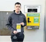  ??  ?? DISGUSTED: Aeddonate chief executive Jamie Richards with the parking ticket and the new defibrilla­tor.