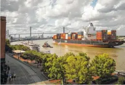  ?? AP PHOTO/STEPHEN B. MORTON, FILE ?? The container ship Zim Istanbul makes its way up the Savannah River past historic River Street in Savannah, Ga. Visitors can enjoy cruises on the river along with sightseein­g in the city's historic district, food tours and 22 squares that make for...