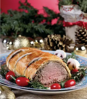 ?? HILLARY LEVIN St. Louis Post-Dispatch/TNS ?? Beef Wellington begins with a beef tenderloin, which is wrapped in a thin layer of duxelles. Then the duxelles-wrapped meat is wrapped again with a thin layer of prosciutto, and then it is wrapped one last time, in a layer of puff pastry, before it is all baked together into a golden loaf.