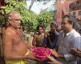  ?? DEEPA BHARATH — THE ASSOCIATED PRESS ?? Arjun Viswanatha­n places his hands on a basket of flowers to be offered to the Hindu deity Ganesh at the Sri Lakshmi Visa Ganapathy Temple in Chennai, a city on the southern coast of India, on Nov. 28.