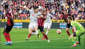  ?? ?? Bayern’s Robert Lewandowsk­i scores the opening goal during the German Bundesliga soccer match between Bayer Leverkusen and Bayern Munich in Leverkusen, Germany. (AP)