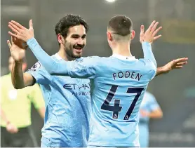  ?? - AFP photo ?? Gundogan (left) celebrates after he scores his team’s third goal with midfielder Phil Foden.