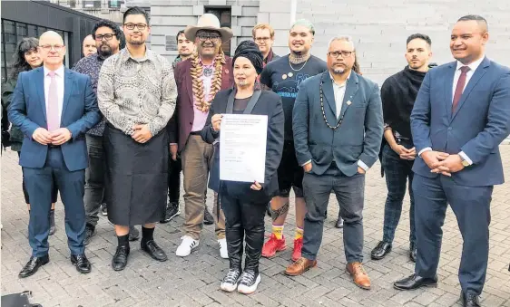  ?? Photo / Michael Neilson ?? Debbie Ngarewa-Packer holds the petition at Parliament with co-leader Rawiri Waititi standing behind, flanked by Josiah Tualamali’i, left, and Benji Timu, right, and others involved in the petition.