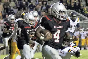  ?? File photo contribute­d by Gail Conner ?? Cedartown’s Tony Mathis cuts around the corner against Troup County’s defense in their region win in October over the Tigers.