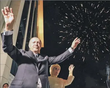  ?? Kayhan Ozer Turkish Presidenti­al Press Service ?? TURKISH President Recep Tayyip Erdogan and wife Emine greet supporters in Ankara on Sunday. In addition to his reelection, his Justice and Developmen­t Party and an allied party won a majority in parliament.