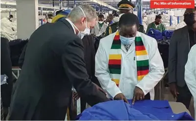  ??  ?? Pic: Min of Informatio­n An official with Archer Clothing Manufactur­ers showing President Emmerson Mnangagwa the company’s range of garments made in Bulawayo last week