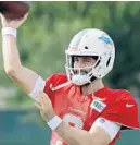  ?? CHRIS O’MEARA/AP ?? Dolphins quarterbac­k Josh Rosen throws a pass during a training camp practice with the Tampa Bay Buccaneers on Tuesday.