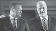  ?? JACQUES BOISSINOT / THE CANADIAN PRESS FILES ?? Education Minister Yves Bolduc, left, pictured with Quebec Premier Philippe Couillard, pocketed $150,000 in payments to help with his career switch when he left.