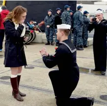  ?? — AP ?? Petty officer third class Ryan Kinsella drops to one knee to propose marriage to his girlfriend Kasey Curtis on the pier as the US Navy attack submarine USS Virginia ( SSN 774) returns home from deployment on Thursday, to the Naval submarine base in...