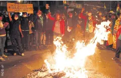  ??  ?? TRADITIONA­L PROTEST: Anti-government ralliers chant around a bonfire demanding a second round of the presidenti­al election in La Paz, Bolivia on Friday.