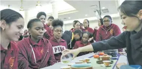  ??  ?? Students from Medgar Evers College Preparator­y School of New York taste Chinese tea during a culture exchange event in New York, US on February 2, 2018.