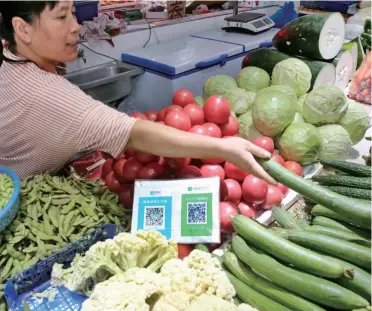  ??  ?? QR codes for payment displayed at a market stall, Nantong City, Jiangsu Province, September 10, 2018