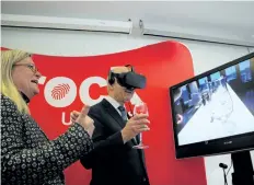  ?? ALLAN BENNER/ STANDARD STAFF ?? Debbie Inglis, director of Brock's cool climate oenology and viticultur­e institute, gives Reza Moridi, Ontario's minister of research innovation and science, a demonstrat­ion of virtual reality technology to be developed with new provincial funding.