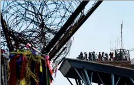  ?? JUNG YEON-JE/GETTY-AFP ?? Visitors to Imjingak park in South Korea look across the Demilitari­zed Zone to North Korea on Monday. North Korean leader Kim Jong Un has proposed talks with the South.