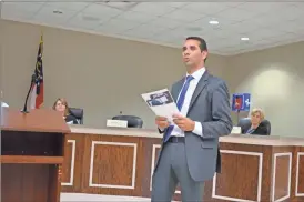  ?? sean Williams ?? Keya Rajabi from Motorola Solutions spoke to the Polk County Commission in a special session on August 29 about new radios and services being offered by his firm.