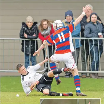 ?? Photos: Neil Paterson ?? Lovat’s Craig Mainland goes down holding both sticks, with Kingussie’s Roddy Young.