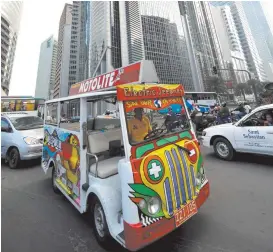  ??  ?? PHOTO SHOWS a battery powered “jeepney” making a daily trip in Manila’s financial district. The rides, which were for free, were financed by the city government as part of a campaign to reduce its greenhouse emissions.