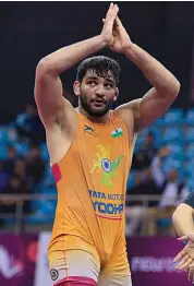  ??  ?? Sunil Kumar celebrates his 5-0 win over Azat Salidinov of Kyrgyzstan 5-0 in the 87kg summit bout at the Asian Wrestling Championsh­ips in New Delhi on Tuesday.