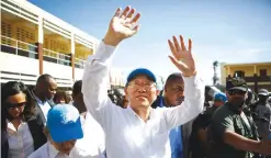  ??  ?? LES CAYES, Haiti: In this file photo, United Nations Secretary-General Ban Ki-moon waves to people whose homes were destroyed by Hurricane Matthew, as he visits a school where they have sought shelter. — AP