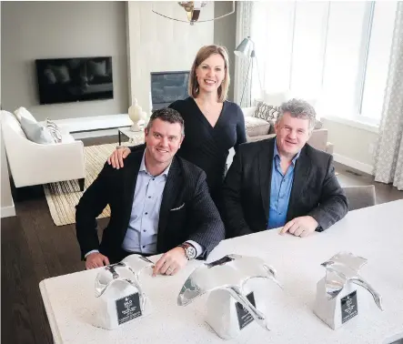  ?? CHRISTINA RYAN ?? Builder of the Year: Calbridge Homes president and CFO Bev Higham-Linehan, centre, with the company’s senior vice-presidents Andrew Linehan, left, and Tony Robinson at the builder’s award-winning Brooklyn show home.