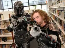  ??  ?? Tiaan Opperman (left) and Aden Appleby as Mandaloria­n bounty hunters at the library.
