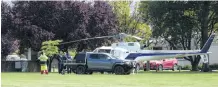  ?? PHOTO: JARED MORGAN ?? Landed . . . An Aspiring Helicopter­s helicopter and search and rescue personnel involved in the search for the downed Cessna 172 and pilot Phillip Pullar gather at Pioneer Park in Alexandra yesterday.