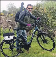  ??  ?? Simon Thorborn zips off on his e-bike.