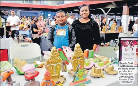  ?? Picture: JONA KONATACI ?? Pratik Dutt with mum displays their products at the Garden City in Suva.