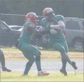  ?? STAFF PHOTO BY ANDY STATES ?? Westlake’s Luquay Washington, right, and his teammates celebrate after Washington’s third-quarter touchdown run in the team’s game against the visiting Thomas Stone Cougars on Saturday afternoon. The Wolverines defeated Stone 21-19.