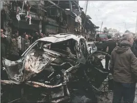  ?? AP ?? Bomb-damaged cars sit at the scene of a large explosion in the coastal Syrian town of Jableh that killed at least 10 people and devastated a number of shops along the commercial street.