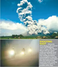  ??  ?? ... Motorists drive along an ash-covered road in the Philippine town of Ligao after Mount Mayon shot up a giant mushroom-shaped cloud yesterday. The volcano’s new activity prompted volcanolog­ists to raise the alert level one notch higher than the...