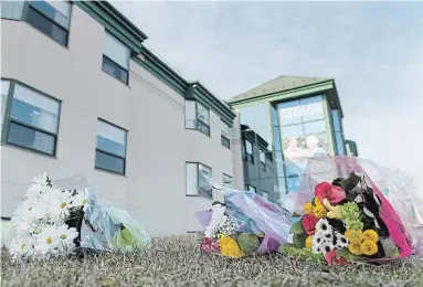  ?? GRAHAM HUGHES THE CANADIAN PRESS ?? Flowers lay on the ground outside Maison Herron, a long-term-care home in Dorval, Que. Quebec’s move to grant more families access to their loved ones who are dying was striking, and maybe Ontario should follow, writes Bruce Arthur.