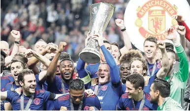  ?? AP ?? Manchester United’s captain, Wayne Rooney, holds the trophy after they defeated Ajax 2-0 in the Europa League final at the Friends Arena in Stockholm, Sweden yesterday.
