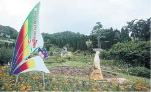  ?? PATIPAT JANTHONG ?? A woman walks through the Winter Flower Garden in Betong, Yala province.