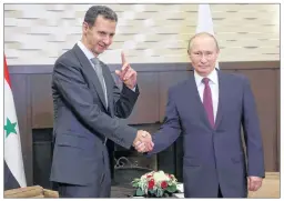  ?? AP PHOTO ?? Russian President Vladimir Putin , shakes hands with Syrian President Bashar Assad during a meeting Monday in the Black Sea resort of Sochi, Russia.