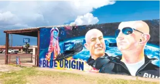  ?? AP PHOTO/SEAN MURPHY ?? The side of a building in Van Horn, Texas, adorned with a mural of Blue Origin founder Jeff Bezos is shown. Bezos plans to launch into space from the Blue Origin spaceport about 25 miles outside of the West Texas town.