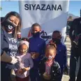  ??  ?? SIYAZANA Youth Developmen­t Fund hot dog distributi­on in Lavender Hill with volunteer Natasha Miller and some of the beneficiar­ies.