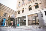  ?? Hani Mohammed / Associated Press ?? Houthi Shiite fighters inspect the scene after two suicide bombings at a mosque in the capital, Sanaa.