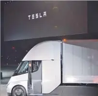  ?? Veronique Dupont AFP/Getty Images ?? MUSK exits a Tesla Semi heavy-duty electric truck during the unveiling in Hawthorne. He said the truck will have a range of 500 miles. Most electric trucks get about 150 miles.