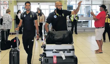  ?? Picture: FREDLIN ADRIAAN ?? ENTER CAULDRON OF FIRE: Keshav Maharaj, left, and Hashim Amla arrive with the Proteas at Port Elizabeth Airport yesterday ahead of the second Test against Australia that begins at St Georges Park on Friday