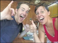  ??  ?? Nate and Jessica Baumgart celebrate the Chicago Cubs’ World Series win at a restaurant in Thailand. The couple lived in Chicago before embarking on a trip around the world.