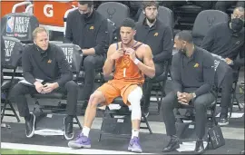  ?? PHOTOS BY PAUL SANCYA — THE ASSOCIATED PRESS ?? Devin Booker sits on the Phoenix bench during the second half of the Suns’ 109-103 loss to the Bucks in Game 4 of the NBA Finals at Milwaukee. Game 5 is tonight at Phoenix.