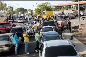  ?? AP/RODRIGO ABD ?? People wait in sometimes mile-long lines to get gasoline last week in Cabimas, Venezuela.