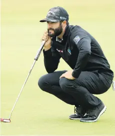  ?? PETER MORRISON/THE ASSOCIATED PRESS ?? Abbotsford’s Adam Hadwin looks over a putt during second-round action at the British Open on Friday. Hadwin had a 70 to sit in a tie for 40th place at the midway point.