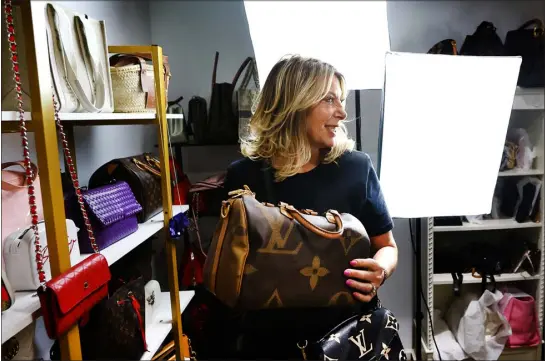  ?? NOAH K. MURRAY — THE ASSOCIATED PRESS ?? Deborah Mayer holds one of the luxury handbags she sells on Tiktok on March 21 in Freehold, N. J. Mayer has sold new and used handbags and other designer goods out of her New Jersey home for 16 years. Early last year, Tiktok recruited her business for the live component of Tiktok Shop.