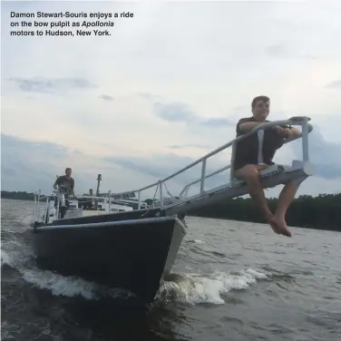  ??  ?? Damon Stewart-Souris enjoys a ride on the bow pulpit as Apollonia motors to Hudson, New York.