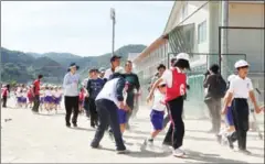  ?? AFP/JIJI PRESS ?? Schoolchil­dren are led by teachers during an evacuation drill at the Abu elementary school in Yamaguchi prefecture yesterday.