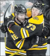  ?? Charles Krupa The Associated Press ?? Bruins defenseman Charlie Mcavoy (73) celebrates with center Pavel Zacha after scoring in the second period of Boston’s 3-1 win over the Flames.